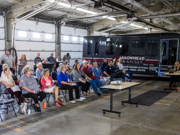 A presenter shared project details with the RideSmart 2025 launch event crowd.