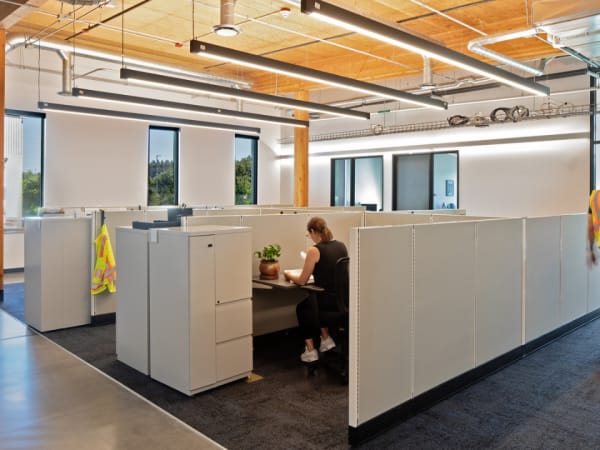 Interior image of C-TRAN's campus expansion work room with cubicles and timber ceiling.