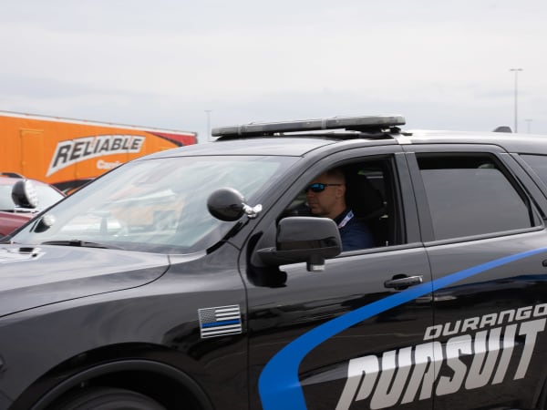 A man is seen driving a black Dodge Durango Pursuit.