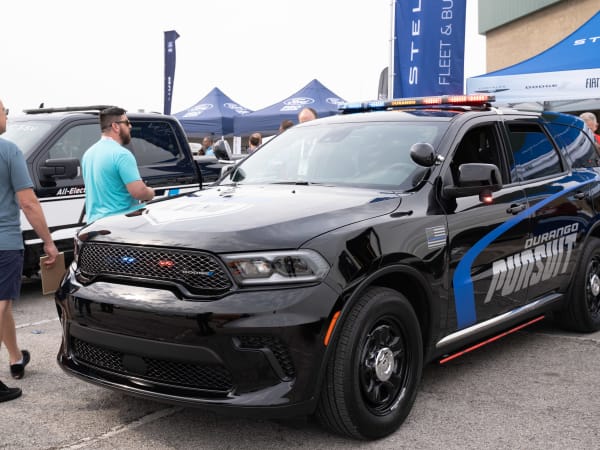 Attendees walk around a Dodge Durango Pursuit, ready for its next test drive.