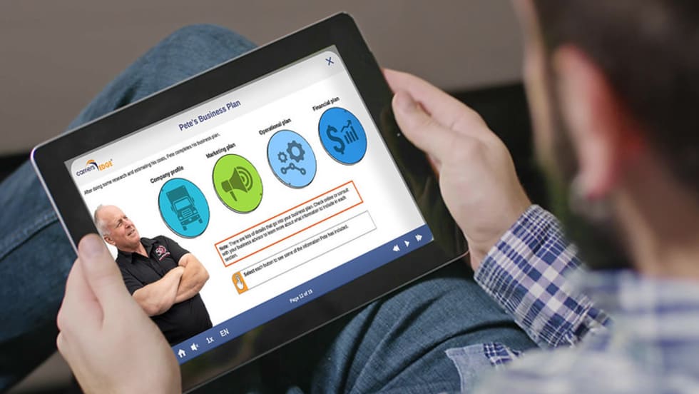 Man looking at training course on electronic tablet