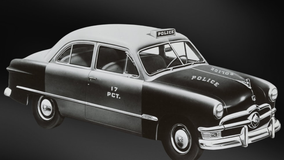 Vintage 1950s Ford police sedan with 17 PCT markings, black and white