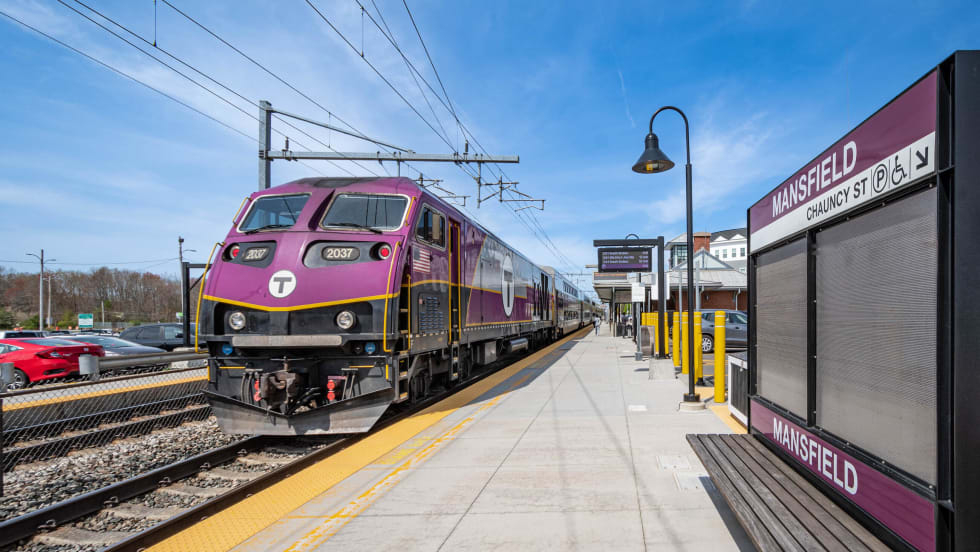 A purple MBTA train at a Mansfield Station platform.