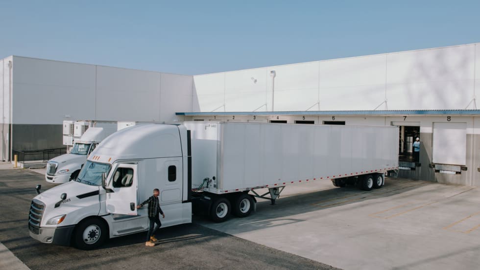 Tractor-trailer backed up to cargo dock