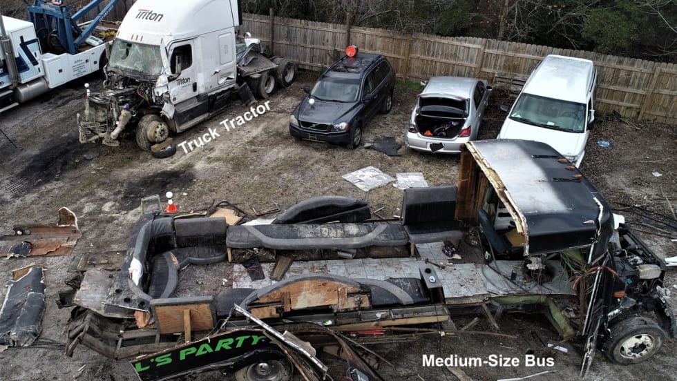 Tow yard photo of truck and bus post-crash