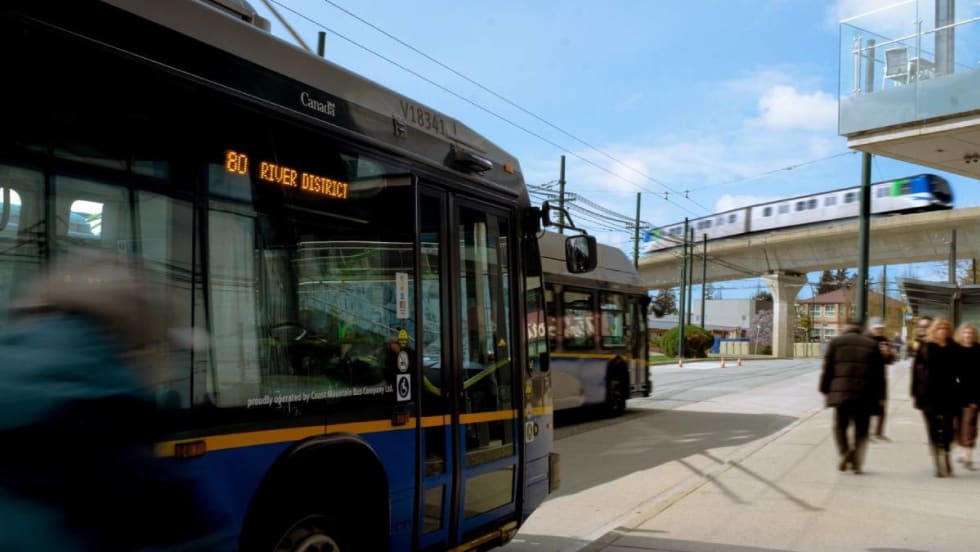 Pedestrians approaching a parked bus.