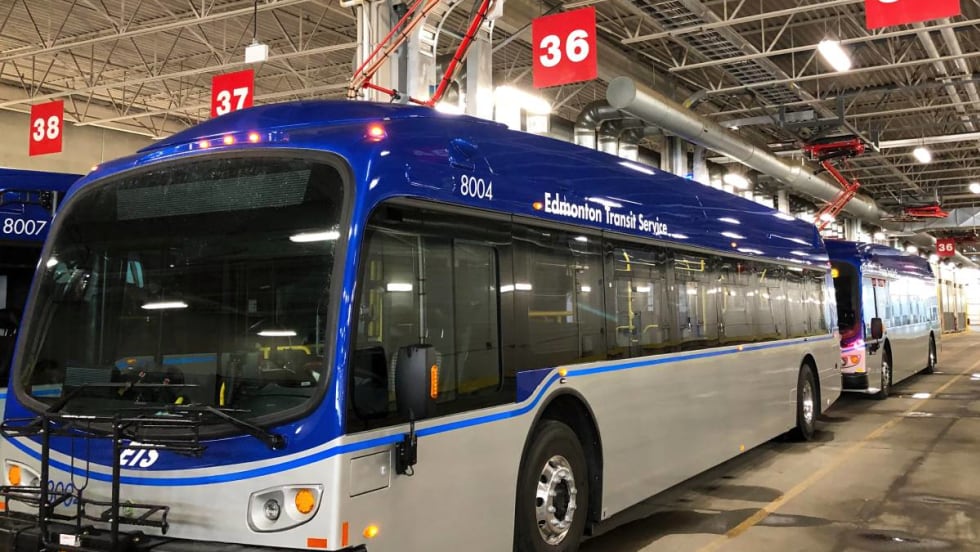 One of Edmonton's electric buses charging from an overhead charging station.
