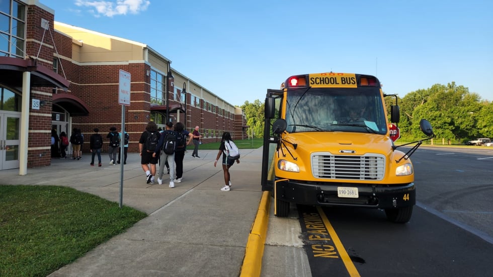 a school bus drops students off
