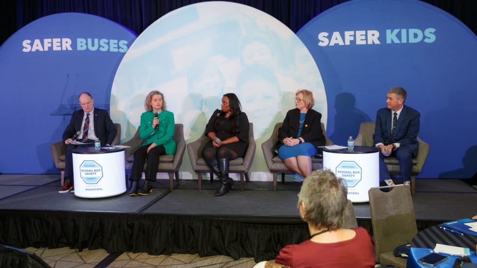 A panel of people on a stage.