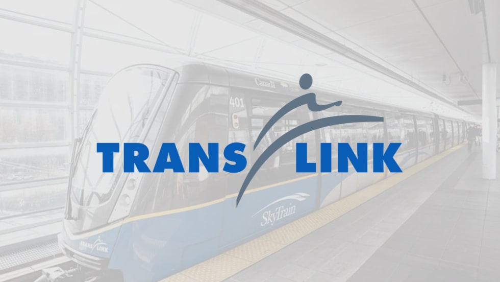 TransLink logo overlaid on a SkyTrain at a station platform in Metro Vancouver.