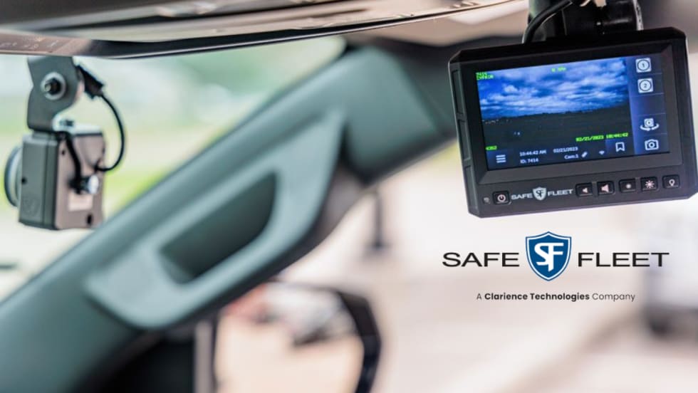 in-car view of windshield and a small screen with a  video image