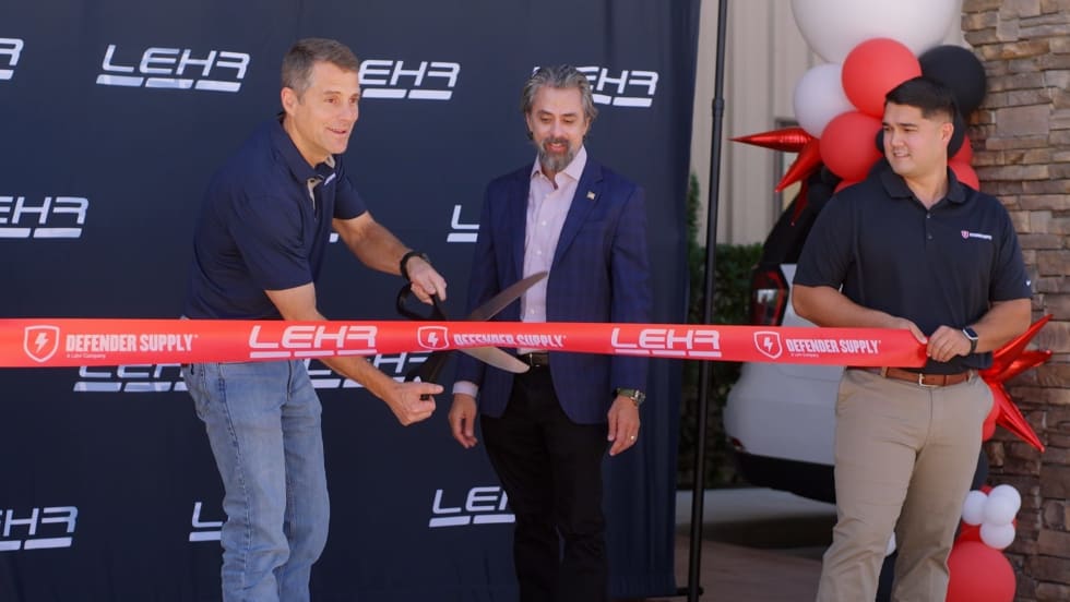 Three mean cut a ribbon.