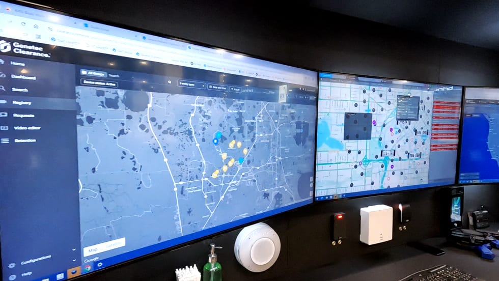 Photo of three computer screens displaying software soluitions in a trade show booth.