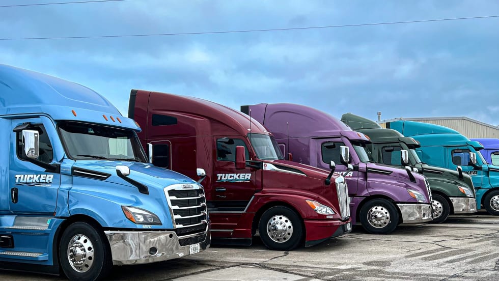 Lineup of colorful Tucker Freight Lines heavy-duty tractors