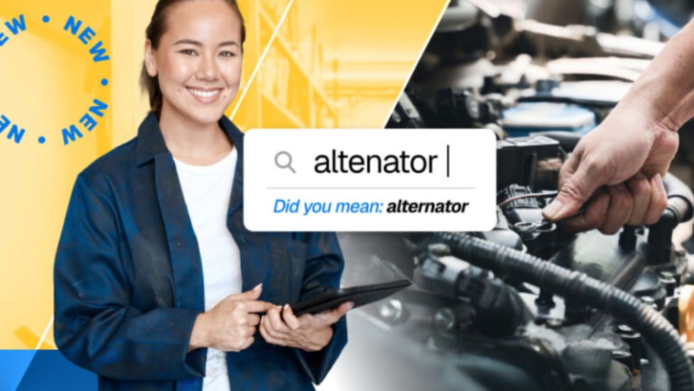 Technician using a tablet with an automotive search screen showing the word “altenator” corrected to “alternator,” representing Mitchell 1’s new “Did You Mean” feature.
