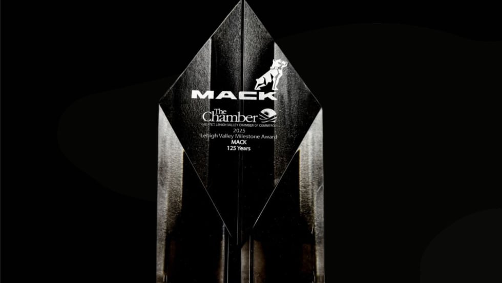 A clear crystal award engraved with “Mack” and “Lehigh Valley Milestone Award 2025 – Mack 125 Years,” displayed against a black background.