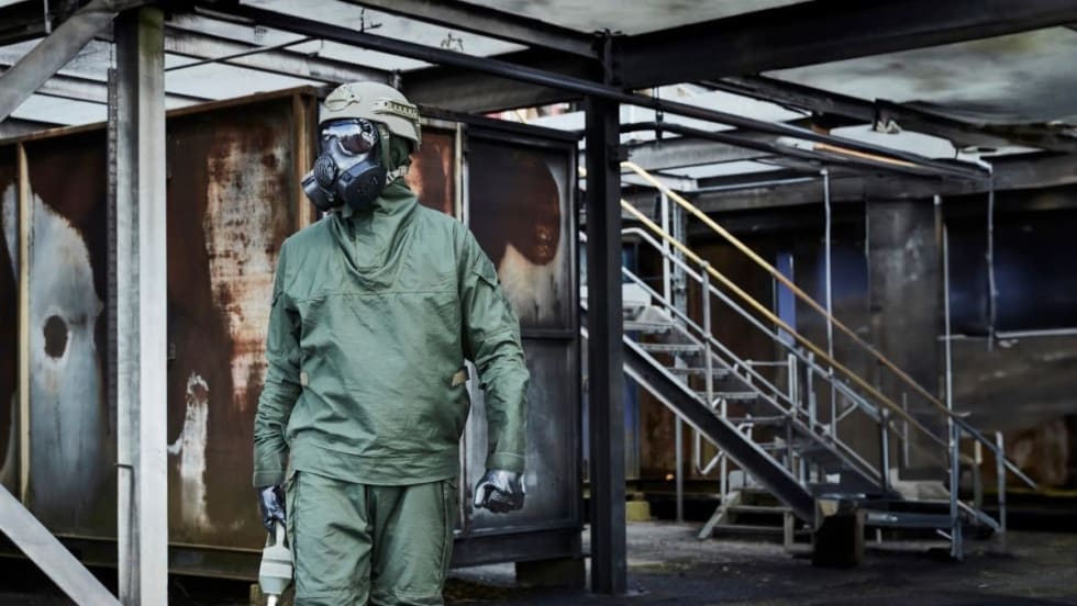 Person in protective CMRN suit and breathing gear.