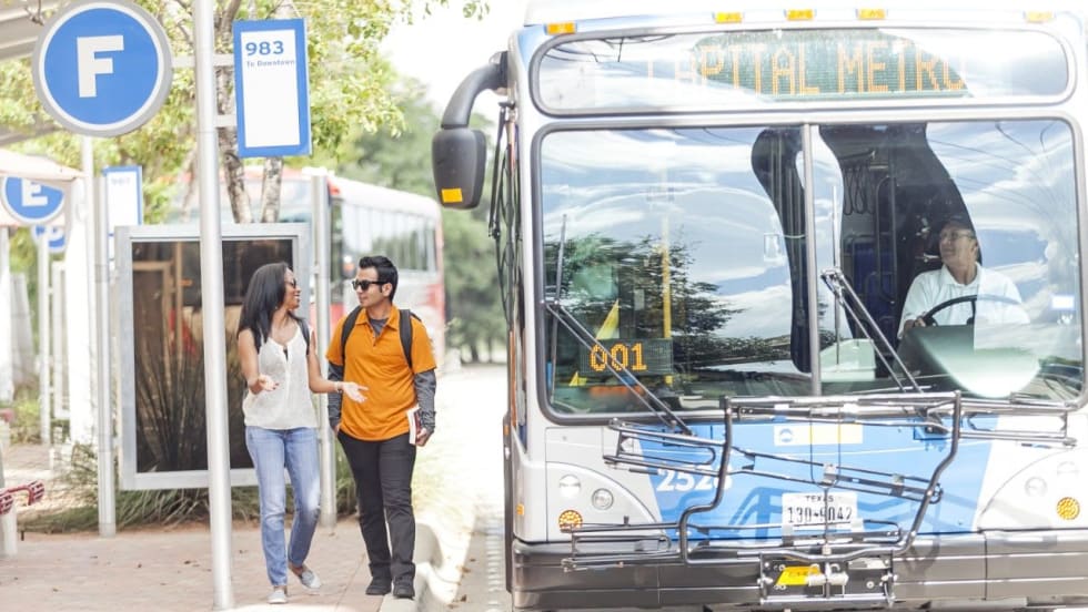 CapMetro customers at a bus stop/