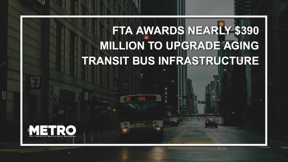 A public transit bus at a pedestrian crosswalk with text reading "FTA Awards Nearly $390 Million to Upgrade Aging Transit Bus Infrastructure Nationwide."