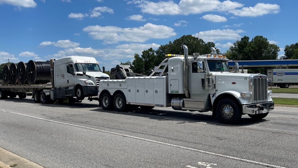 Tractor-trailer being towed.