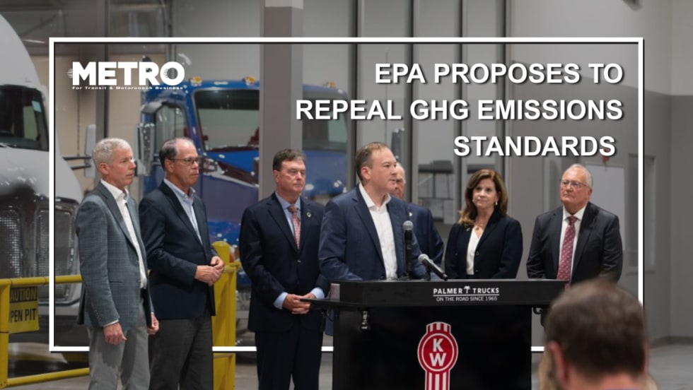 Officials in formal attire stand around a podium.
