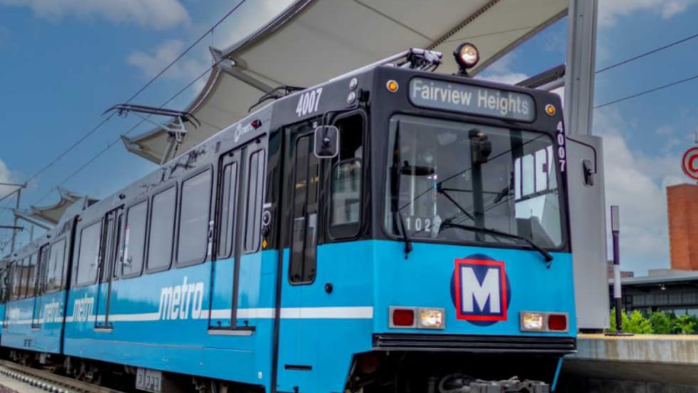 A rendering of a light blue Metro Transit rail car at a station.
