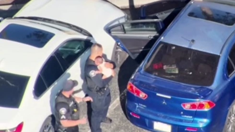 Police officers rescue baby from hot car in California