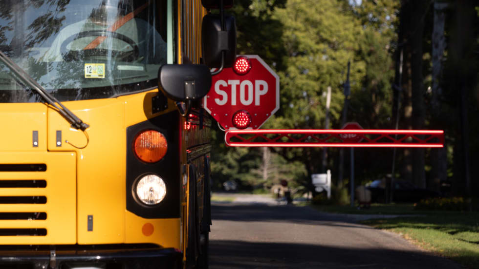A BusGates extended stop-arm actively in use on a school bus.