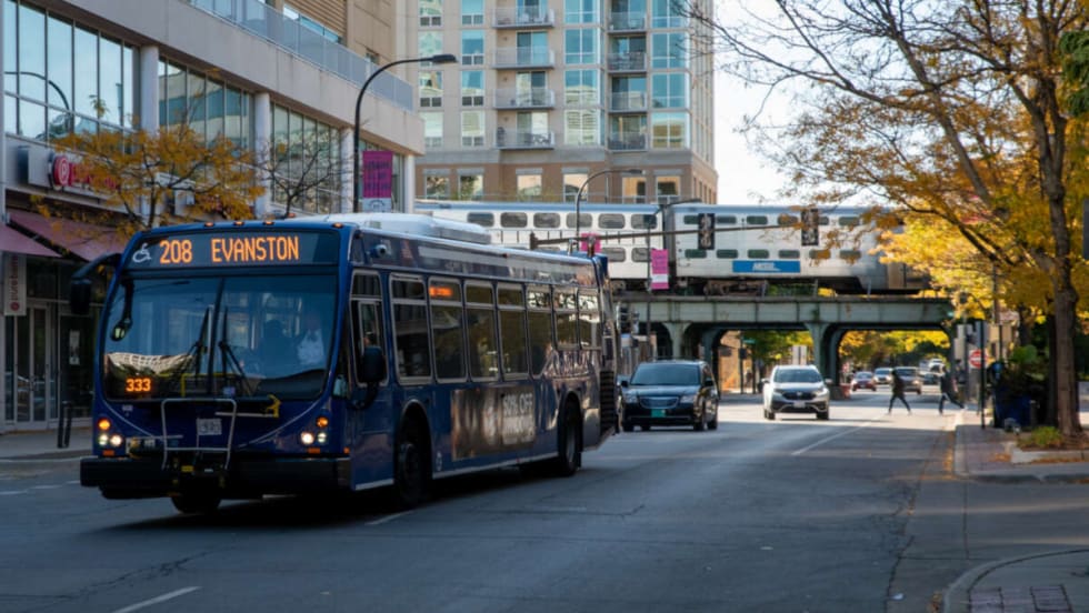 A blue bus on a city street.