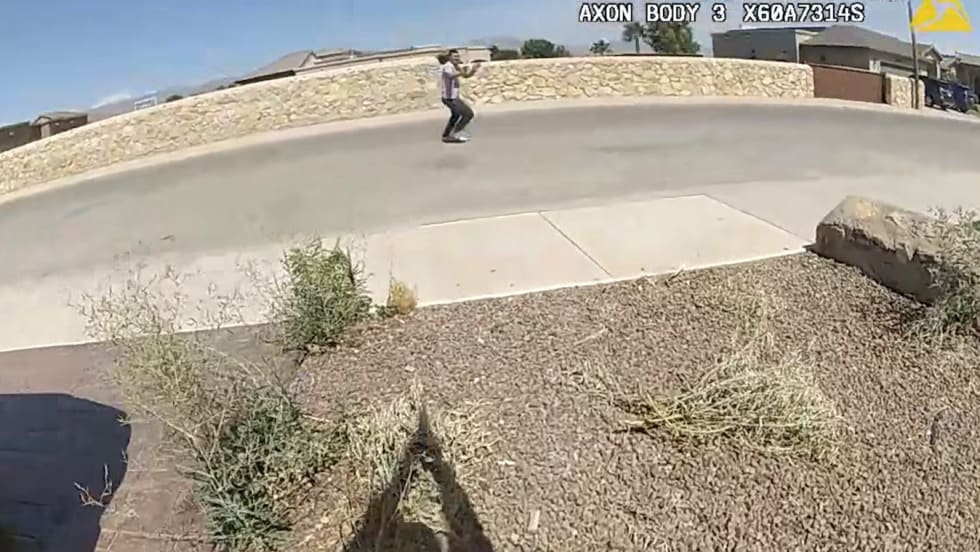 Body camera view of person walking on concrete path near stone wall on sunny day