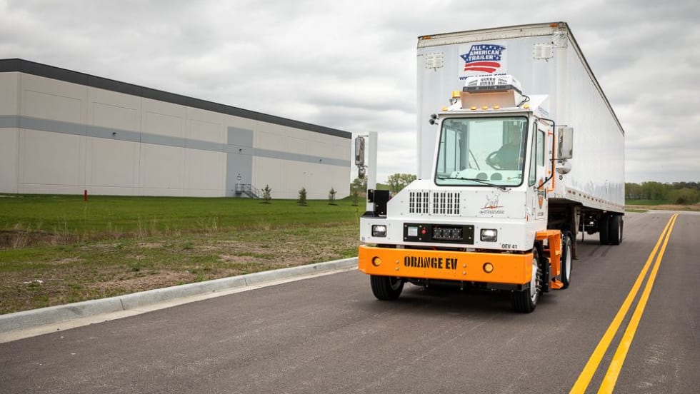 Orange EV terminal tractor. 