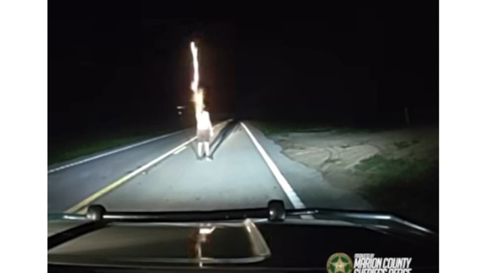 Nighttime dashboard view of police vehicle dashcam with road ahead