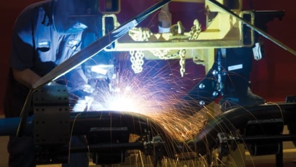 Reyco Granning employ welding a truck suspension. 