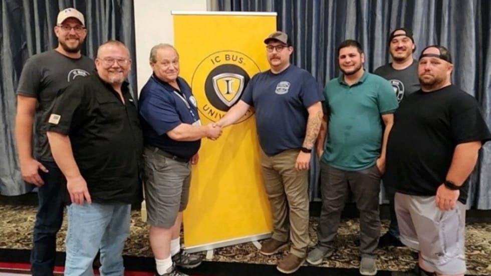 a group of men stand in a conference room