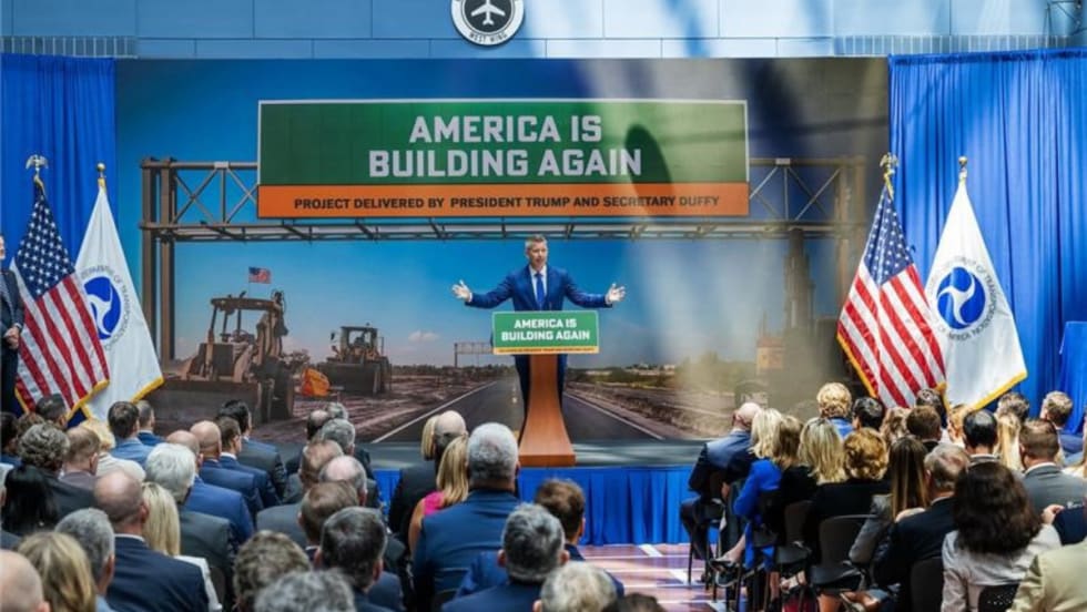 Transportation Secretary Sean Duffy speaks at a podium in front of a crowd.