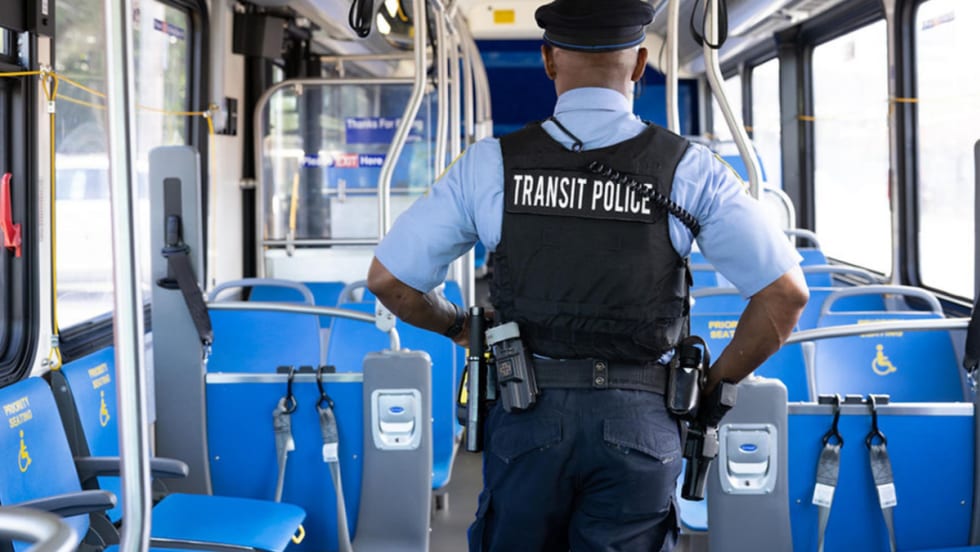 Transit police walks inside an empty SEPTA bus.