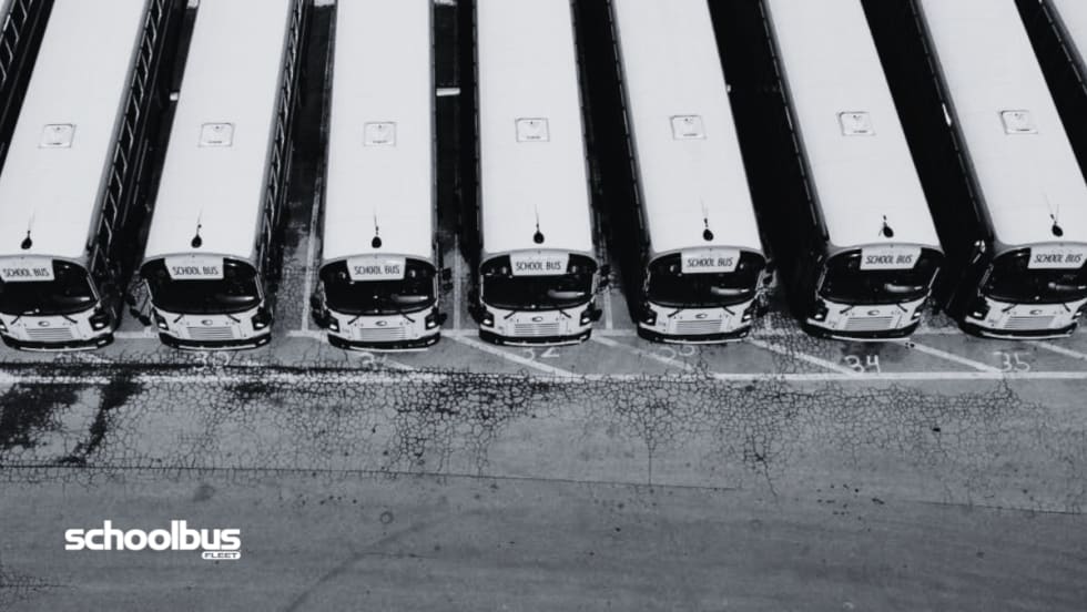 Black and white aerial view of a bus lot.