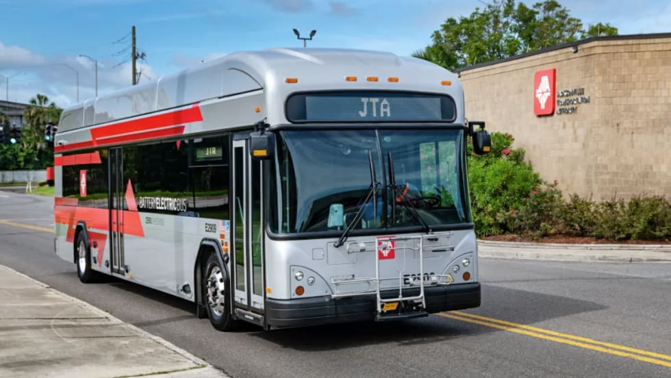 A Jacksonville Transportation Authority bus driving on a road.