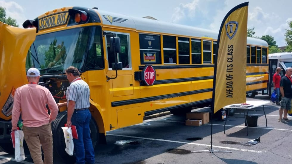Attendees look at the engine of a bus at the 35th Annual Ohio School Bus Mechanics Association Workshop and Vendor Show.