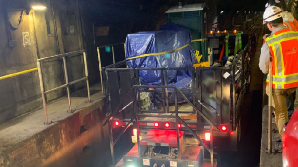 Rail workers enter Line 1 tunnel.