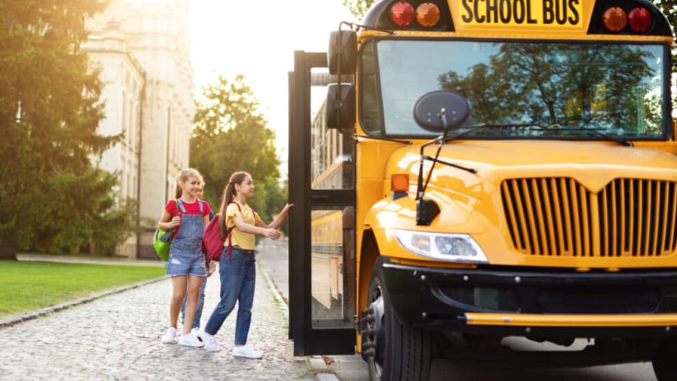 Children boarding a school bus.