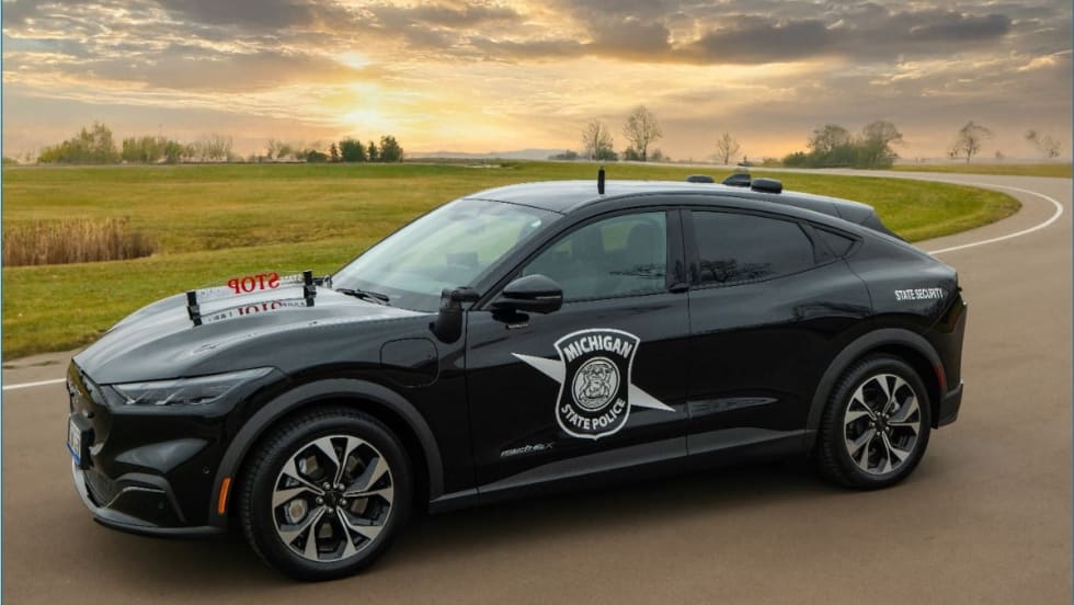 A black Mustang Mach-E is upfitted with Michigan State Police's longtime 'Stop State Police' sign on the hood.