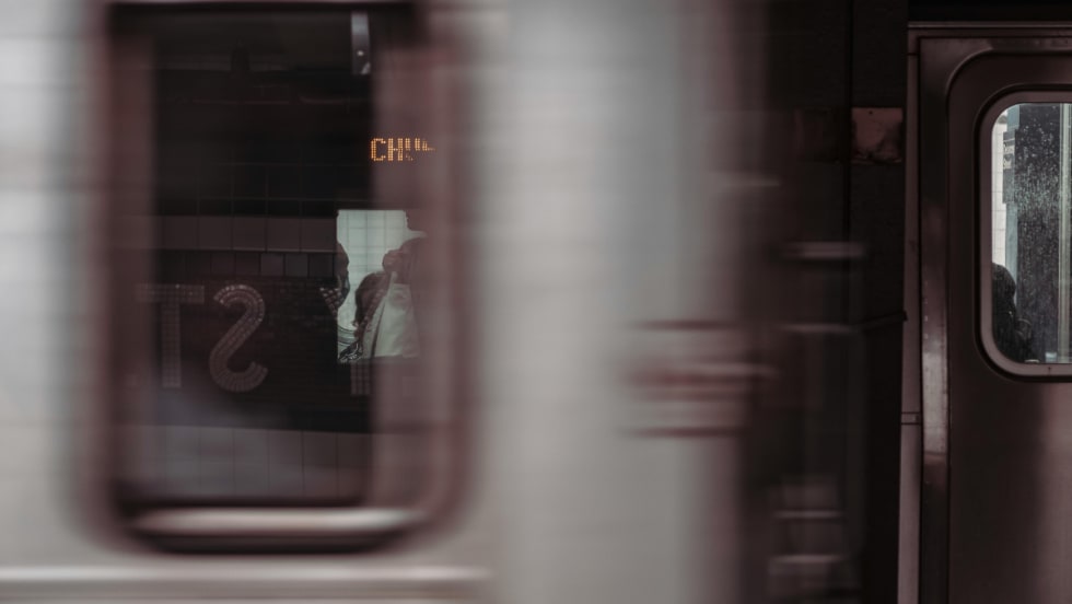 A blurry image of a subway vehicle passing by.