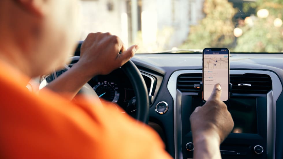 A HopSkipDrive CareDriver uses a mobile navigation app.
