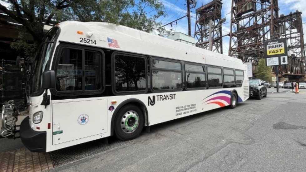 A white NJ Transit bus on a street.