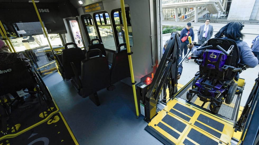 NYTC passenger entering paratransit bus.