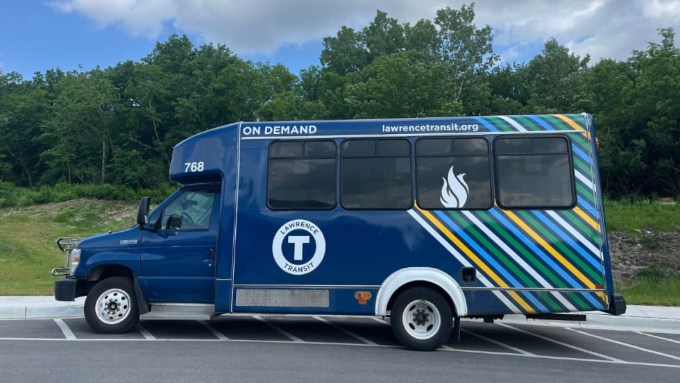 A blue Lawrence Transit on-demand service bus. 
