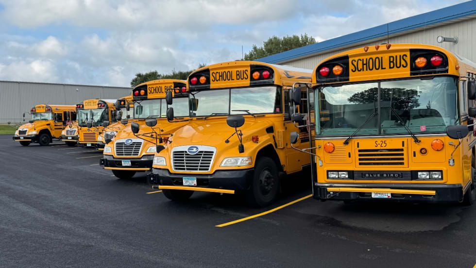 Spanier Bus Service buses lined up in parking spots.
