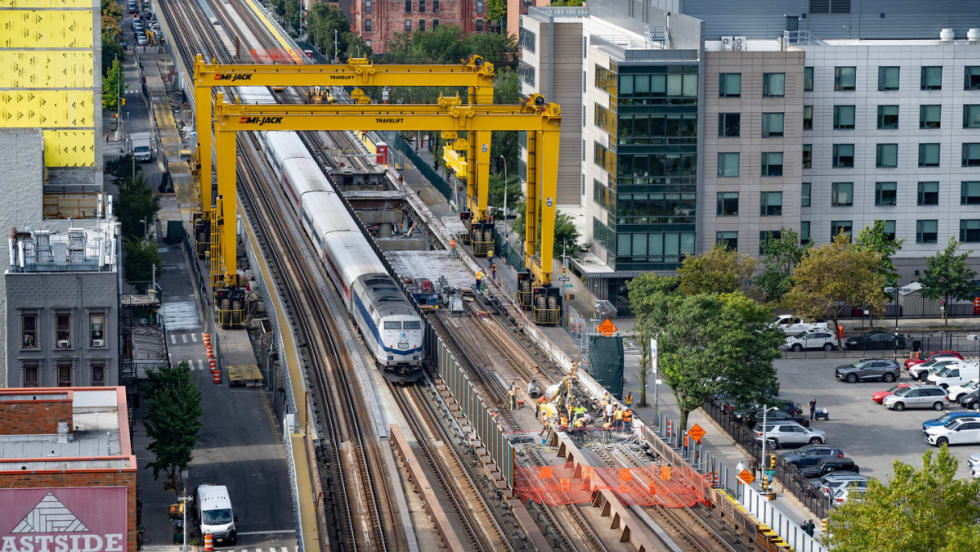 Aerial view of a Metro-North train passing through the gantry system.