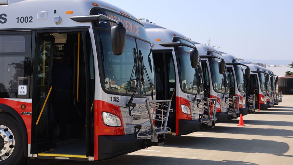 Multiple SamTrans public transit buses lined up.